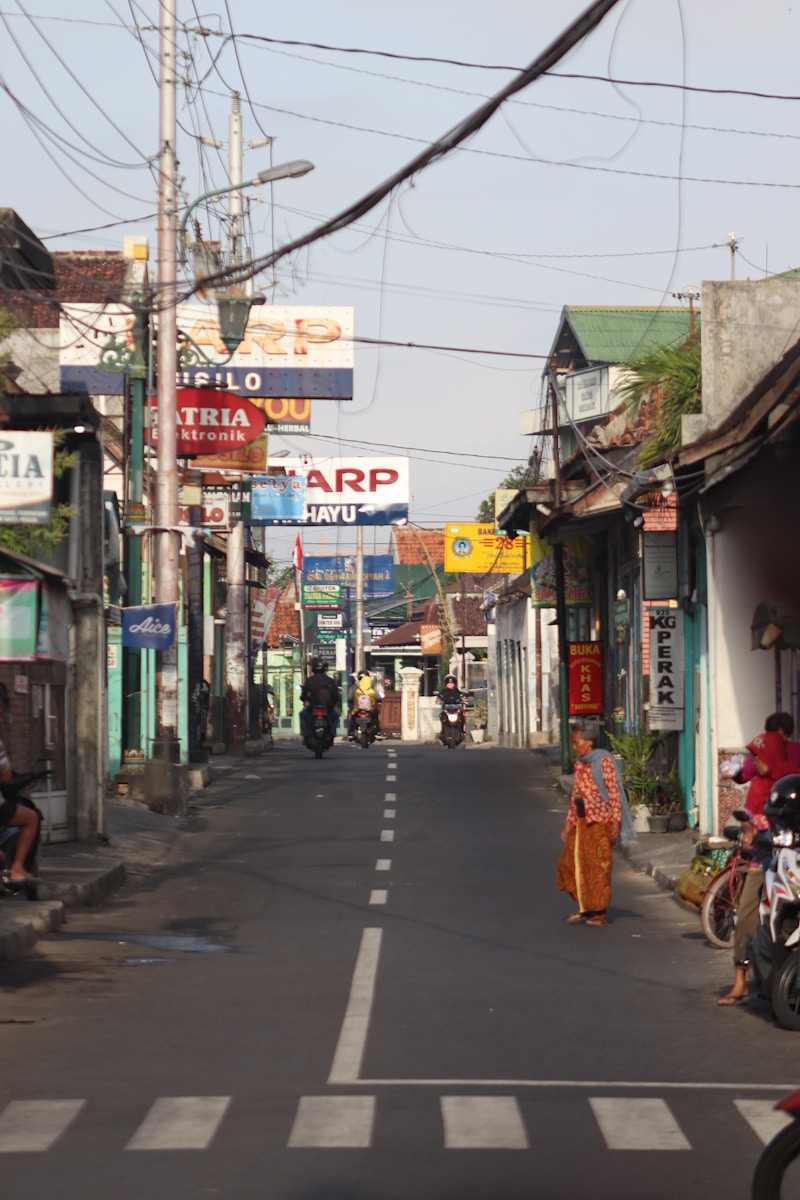 Photo by a maups people walking on sidewalk during daytime
